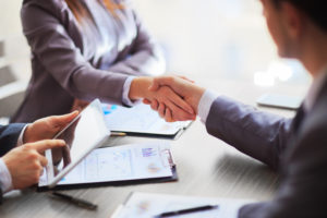 Human resources professionals shaking hands, hiring, resume